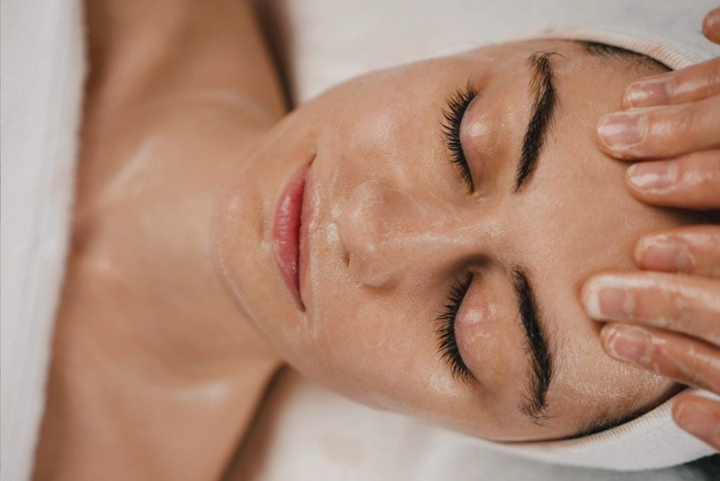 Relaxed woman getting facial message.