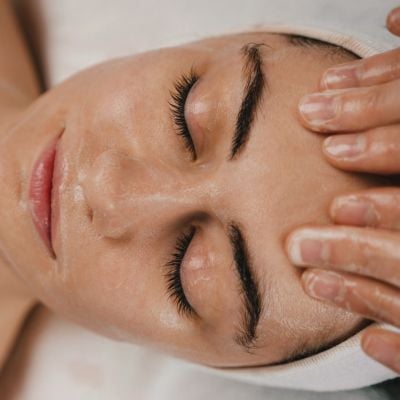 Relaxed woman getting facial message.